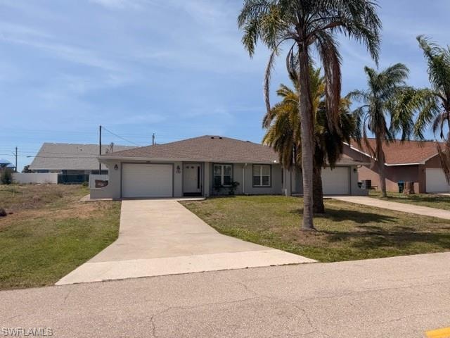 Clean single-story exterior showcasing the attached garage, concrete driveway, and well-kept front yard with mature palms