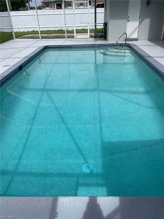 Sparkling in-ground pool with decorative tile waterline border — a fantastic amenity that adds exceptional value to this duplex investment