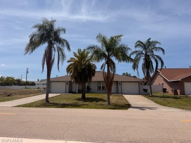 Duplex with neutral exterior, dual single-car garages, and shingle roof — well-presented and tenant-ready