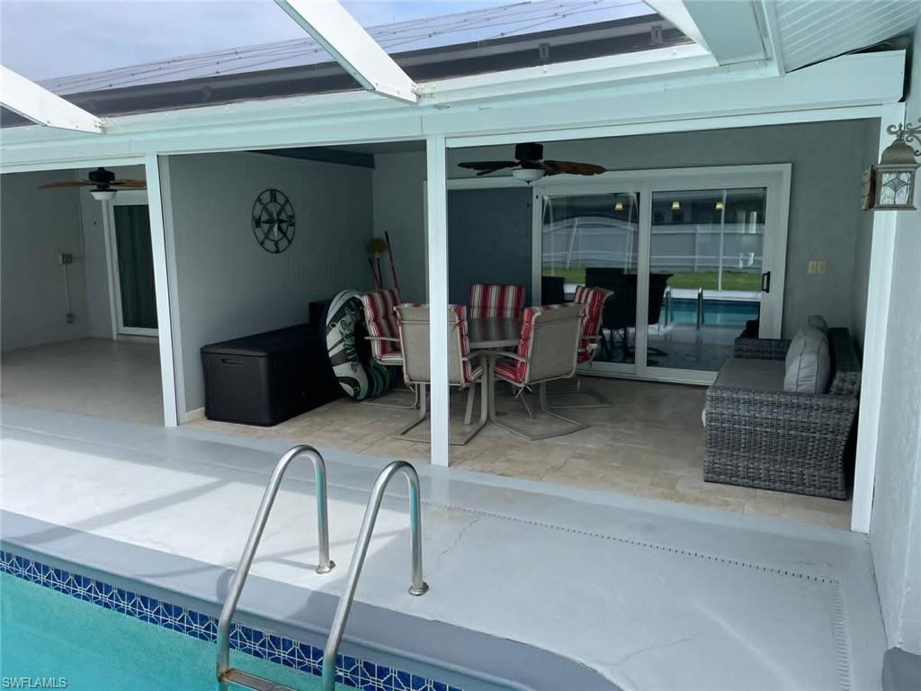Screened lanai with in-ground pool and tiled patio — a resort-style outdoor living area perfect for Florida living