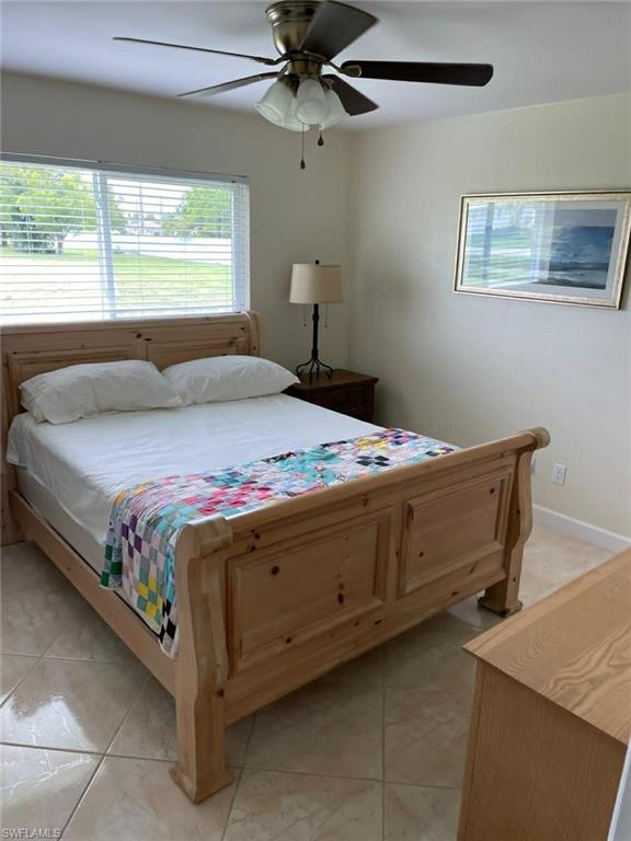 Spacious bedroom with neutral walls and tile flooring — comfortable and low-maintenance for tenants