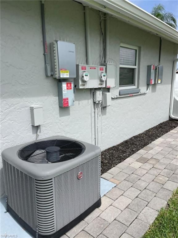 Separate electrical meters and modern Rheem HVAC system — dual metering makes utility management easy for investors