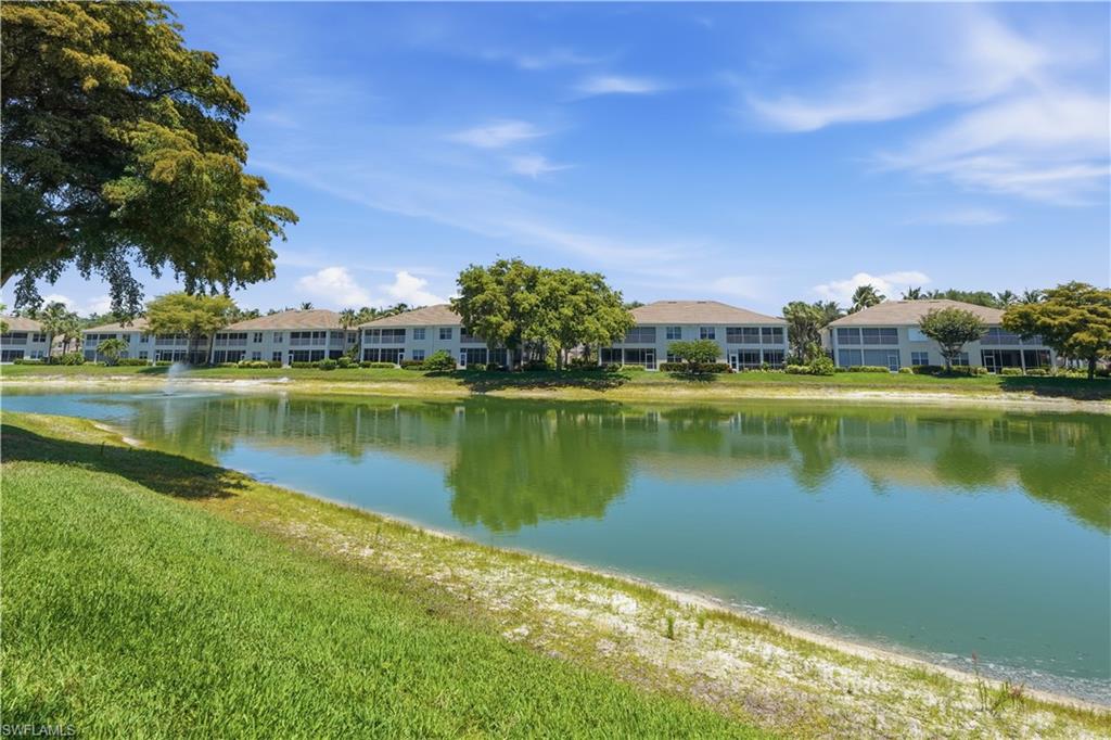 Waterfront condominiums featuring screened lanais, a fountain, and lush perimeter landscaping