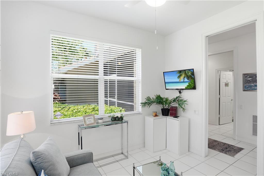 Bright interior space featuring white walls and square tile flooring