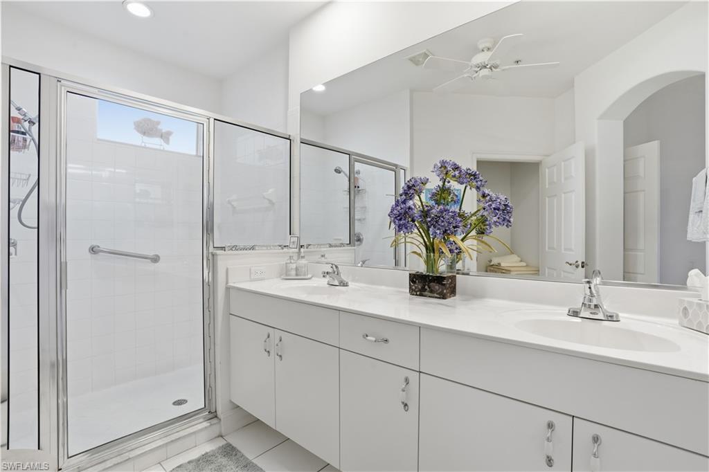 Bathroom vanity with dual undermount sinks, chrome fixtures, and ample countertop space
