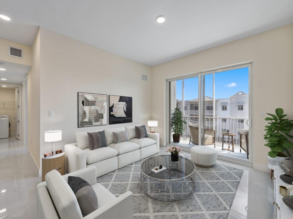 Virtually staged photo. Living area featuring large format tile flooring, and a sliding glass door leading to a private balcony