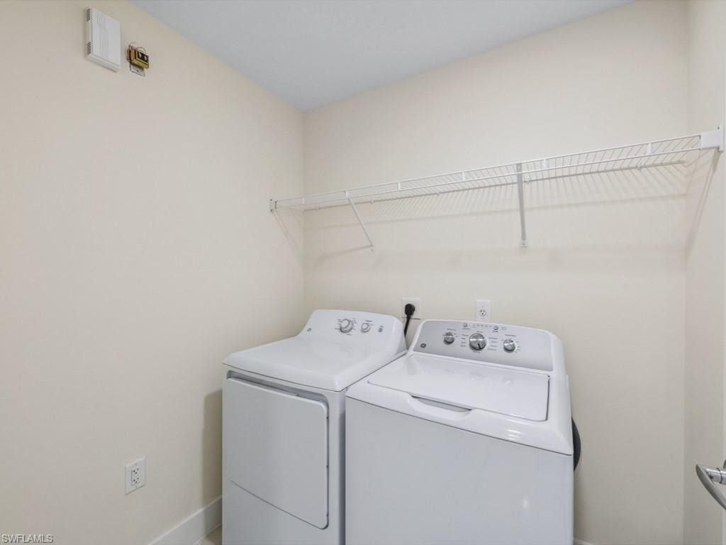 Dedicated laundry space featuring a white wire shelving unit