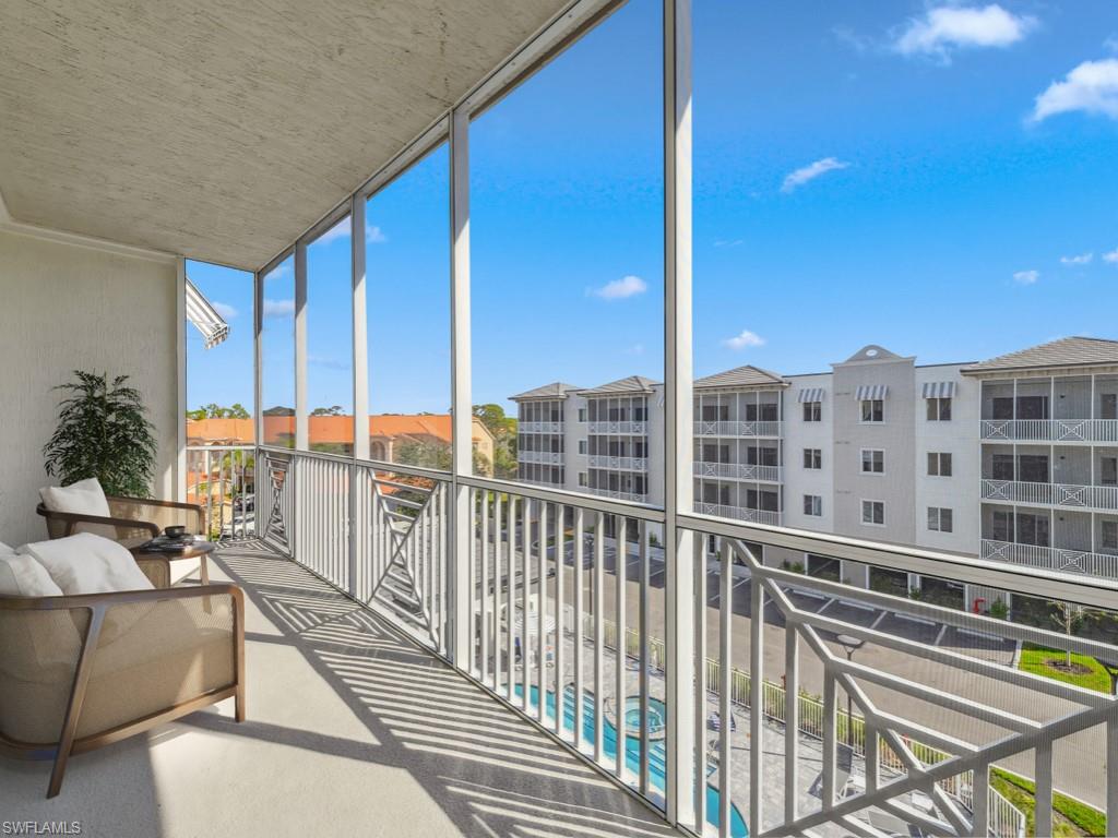 Virtually staged photo. Screened balcony with railings.