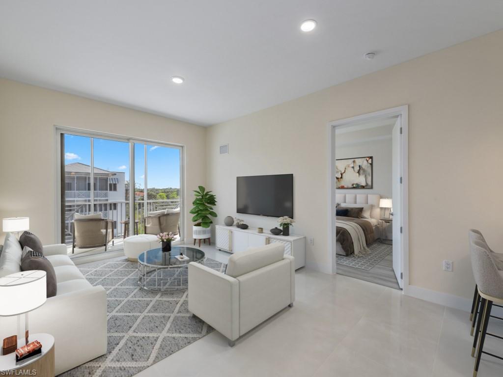Virtually staged photo. Living area with light tile flooring.