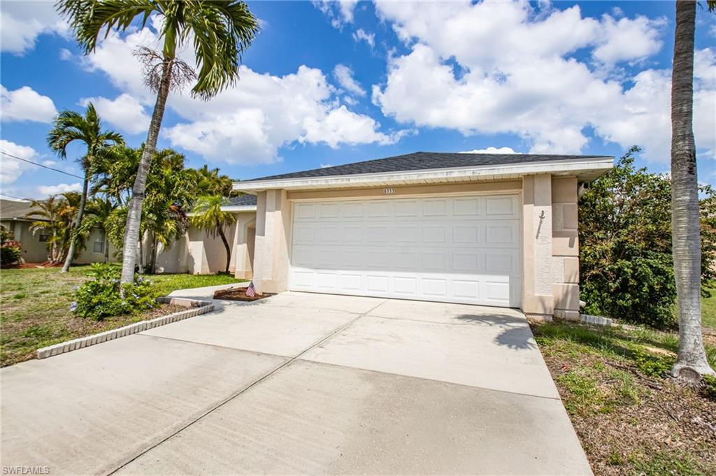 Single-story stucco exterior with an attached two-car garage
