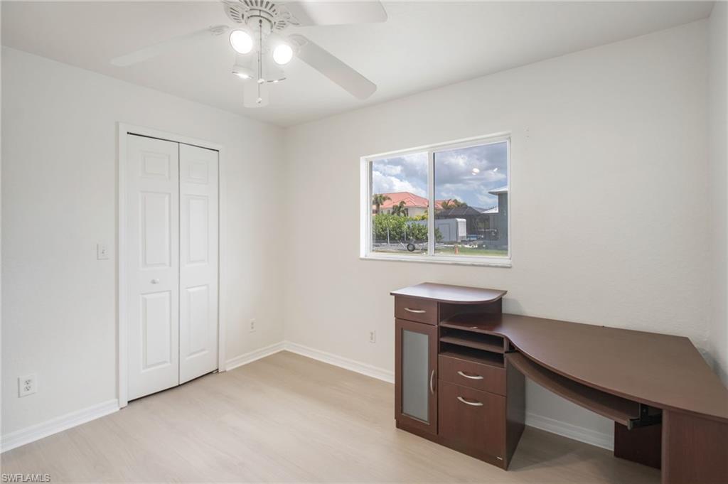 Light-toned wood-finish flooring complements the crisp white walls and bi-fold closet doors