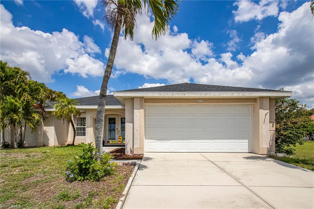 Single-story residence featuring a two-car garage, concrete driveway, and a covered entry