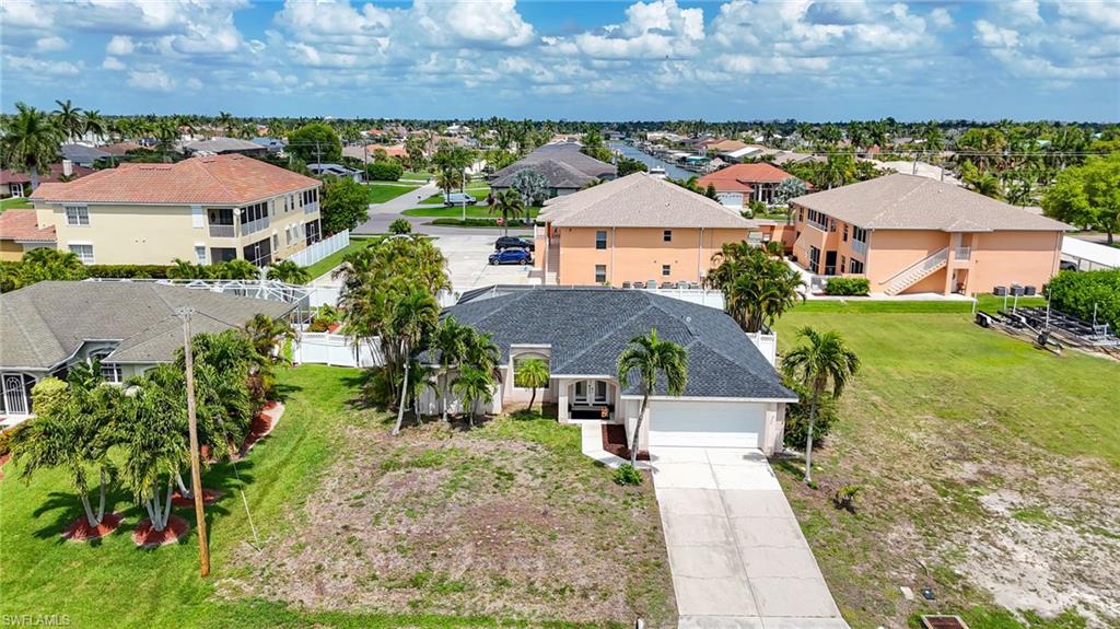 Single-story residence featuring a dark shingle roof, attached two-car garage, and a concrete driveway