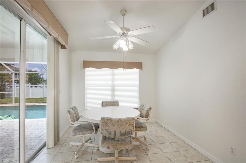 Interior dining space featuring tile flooring and a vaulted ceiling