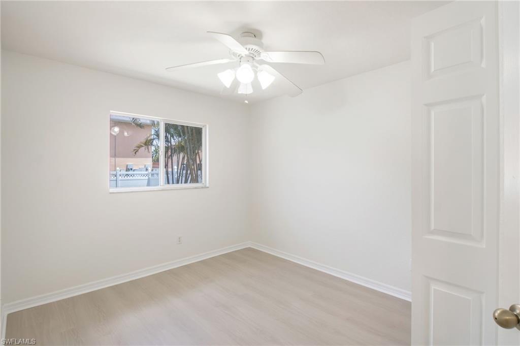 Bright interior space featuring neutral wall finishes and wood-finish flooring