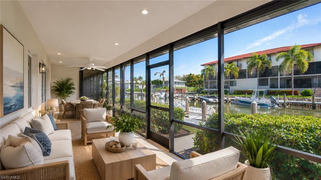 Screened lanai featuring a dining area, recessed lighting, and a ceiling fan