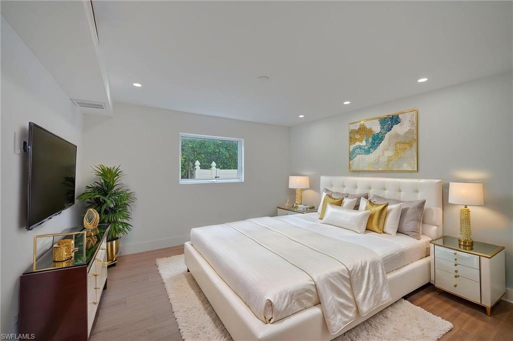 Light-filled interior featuring recessed lighting, a single window, and wood-finish flooring