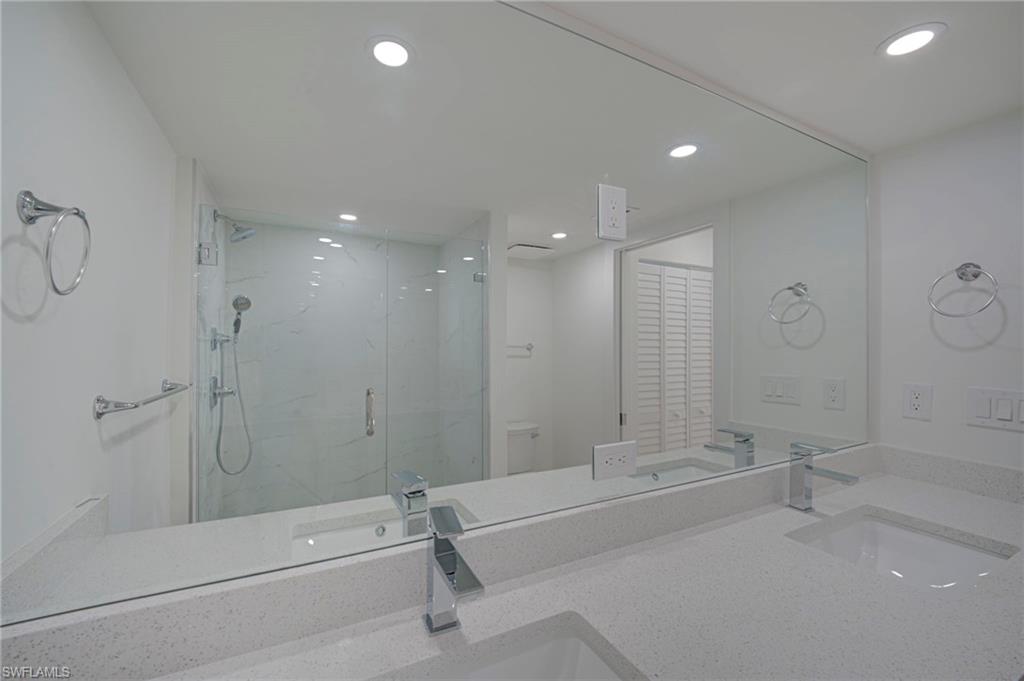 Dual vanity with integrated sinks and chrome faucets, set on a speckled light-toned countertop