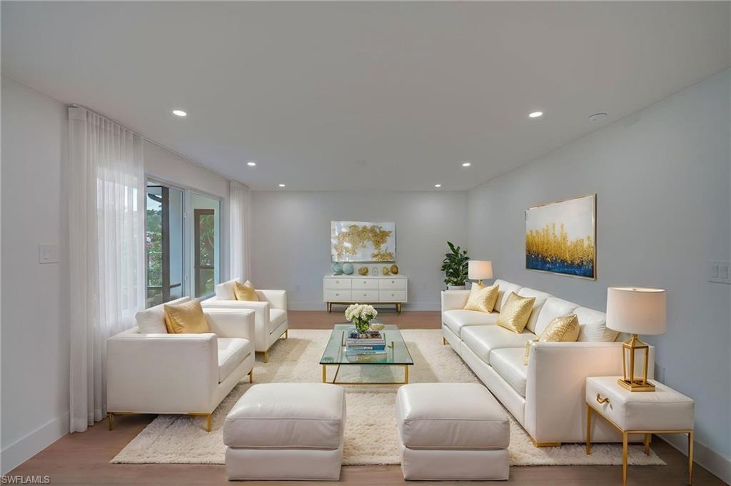 Spacious living room featuring wood-finish flooring and recessed lighting