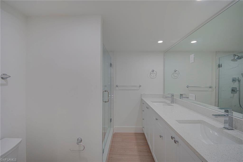 Dual sink vanity with white cabinetry and light-colored countertops