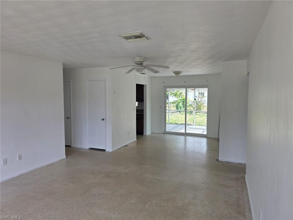 Spacious interior with neutral wall finishes and light-toned carpeting