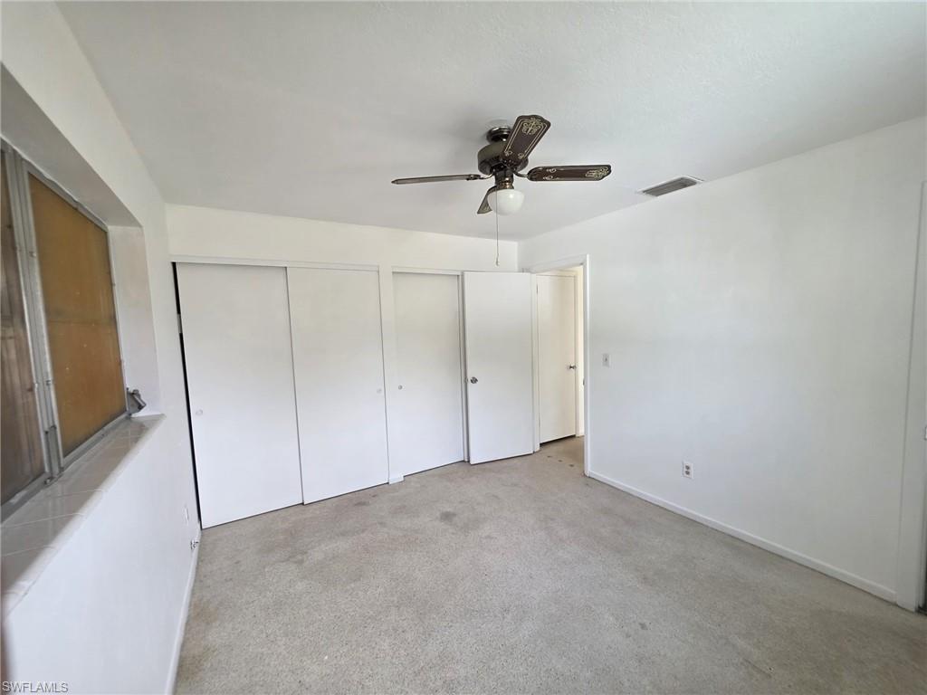 Carpeted interior space with white walls