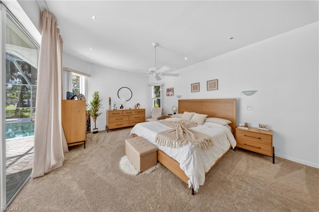 Carpeted room featuring a ceiling fan, recessed lighting, and white walls