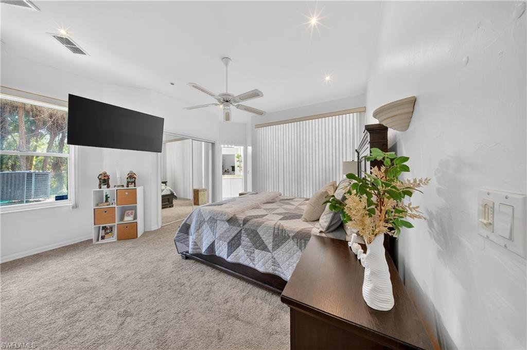 Spacious room with vaulted ceilings and recessed lighting