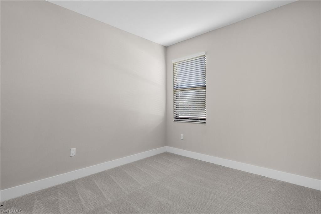 Unfurnished room with baseboards and carpet flooring