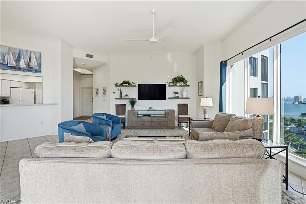 Living space featuring large windows and water scenery