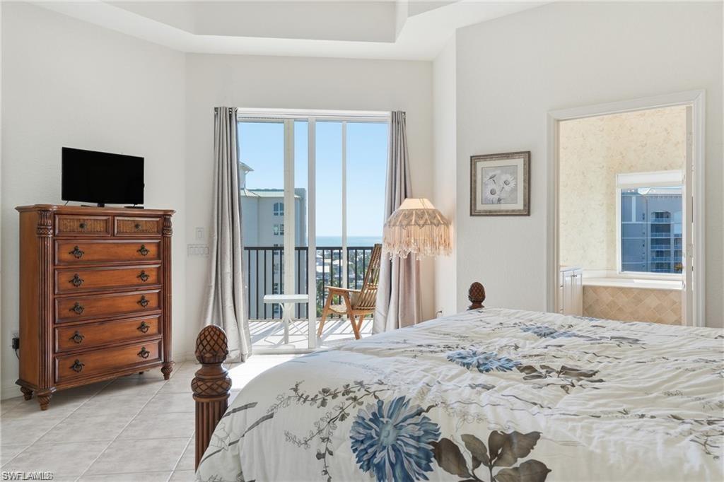 Sliding glass doors opening to a private balcony, offering expansive ocean scenery
