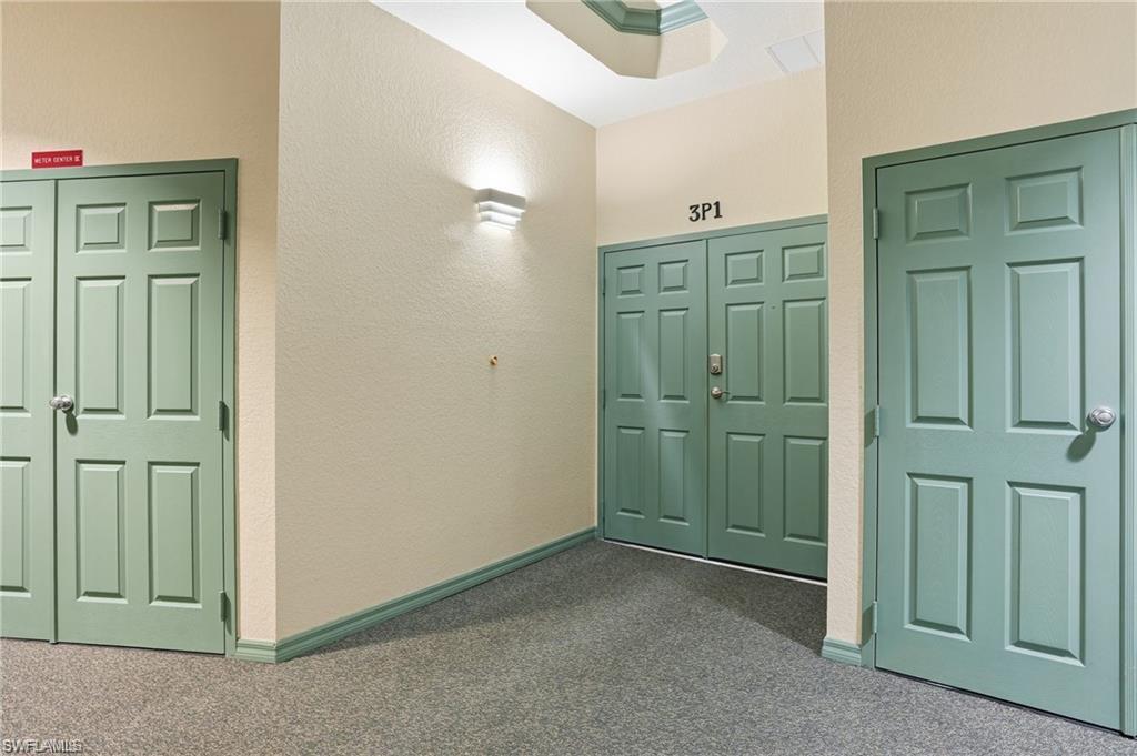 Common area hallway featuring textured walls and recessed ceiling