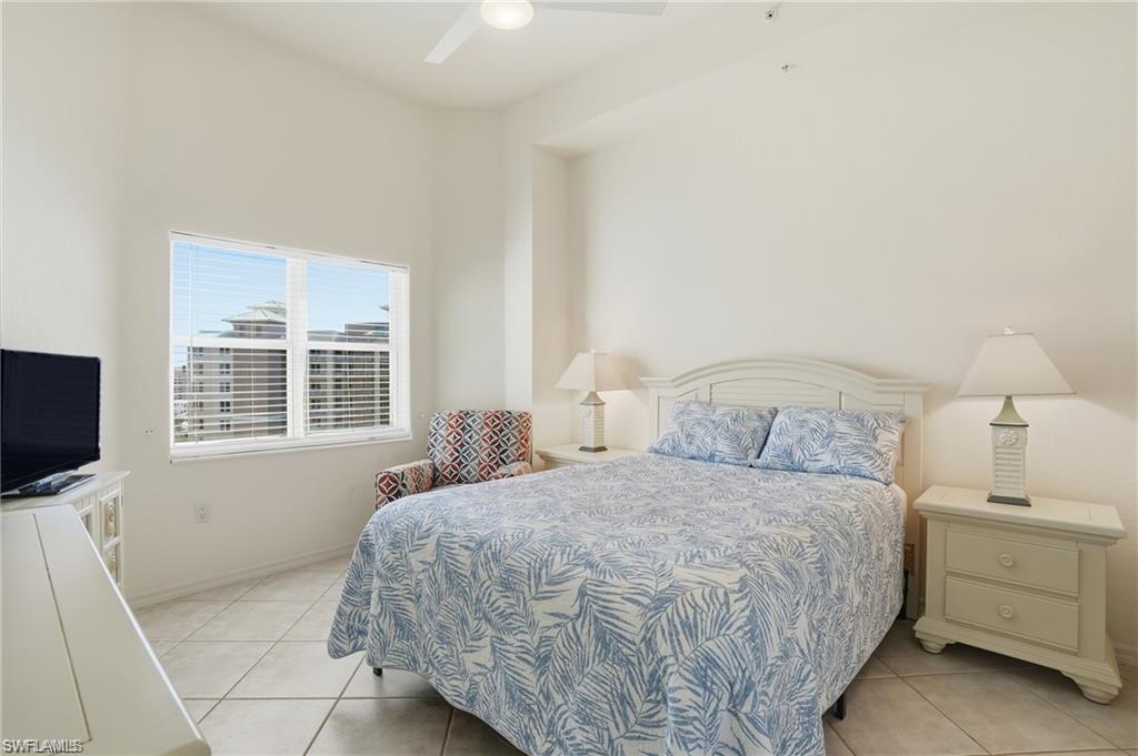 Bedroom featuring a large window, tiled flooring, and a ceiling fan
