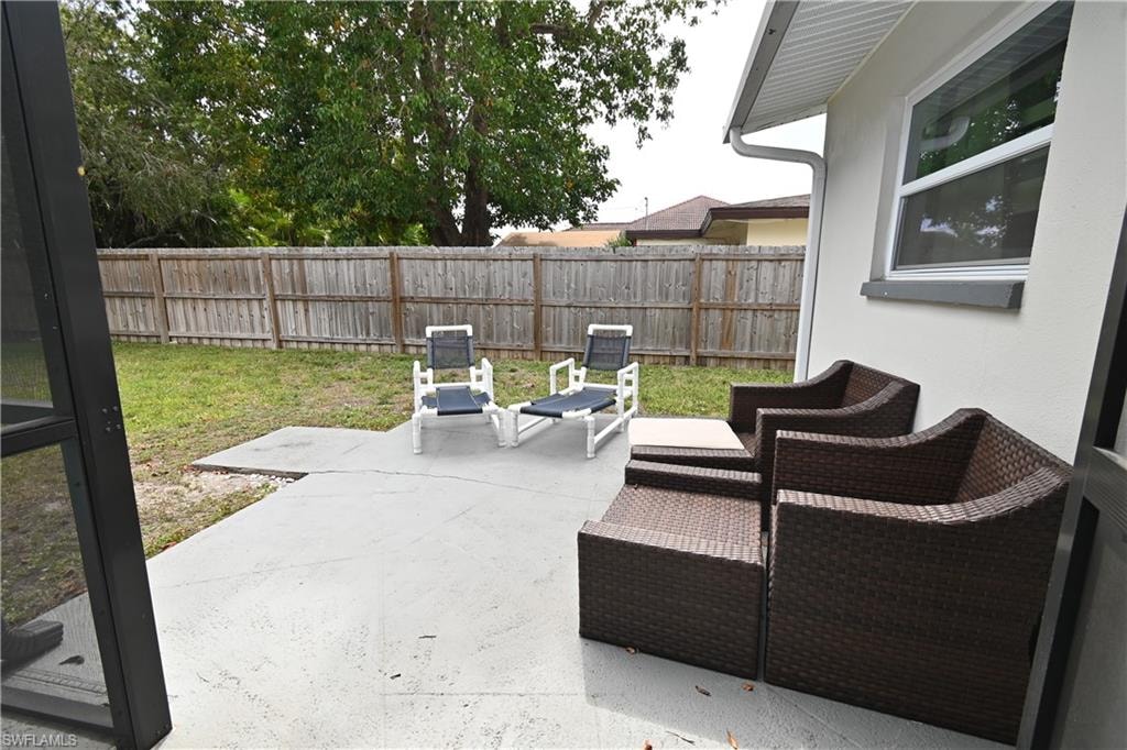 Expansive concrete patio with a stucco exterior and vinyl soffit