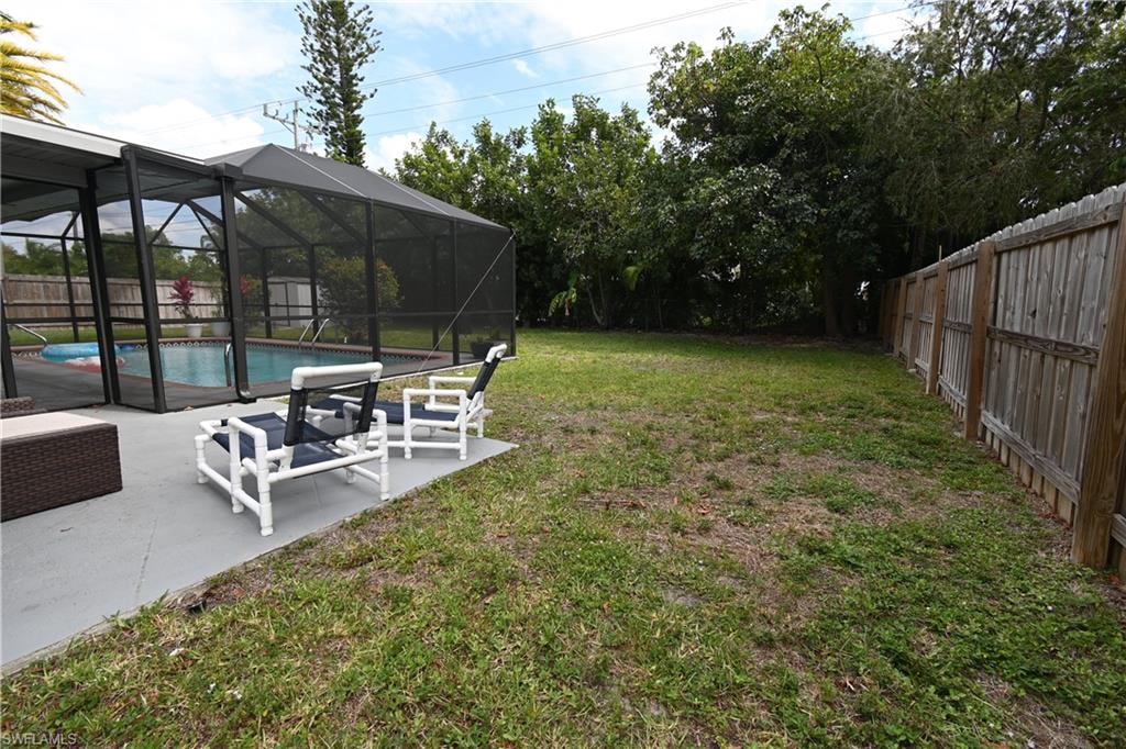 Screened pool enclosure with a concrete patio