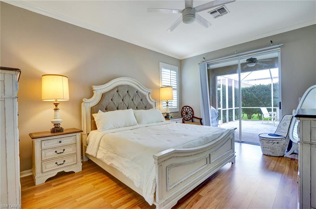 Spacious room with wood-finish flooring and crown molding