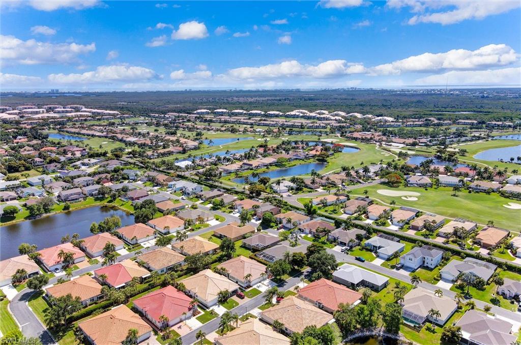 Aerial overview of a residential community featuring extensive green spaces and multiple water features