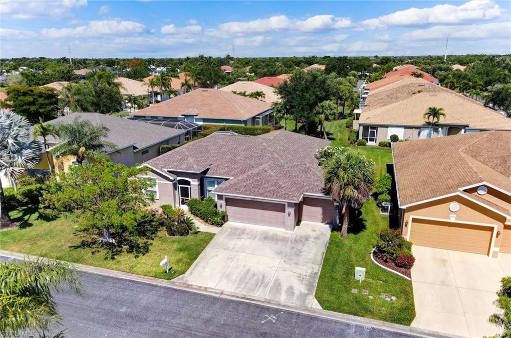 Single-story residence featuring a two-car garage, concrete driveway, and a tiled roof