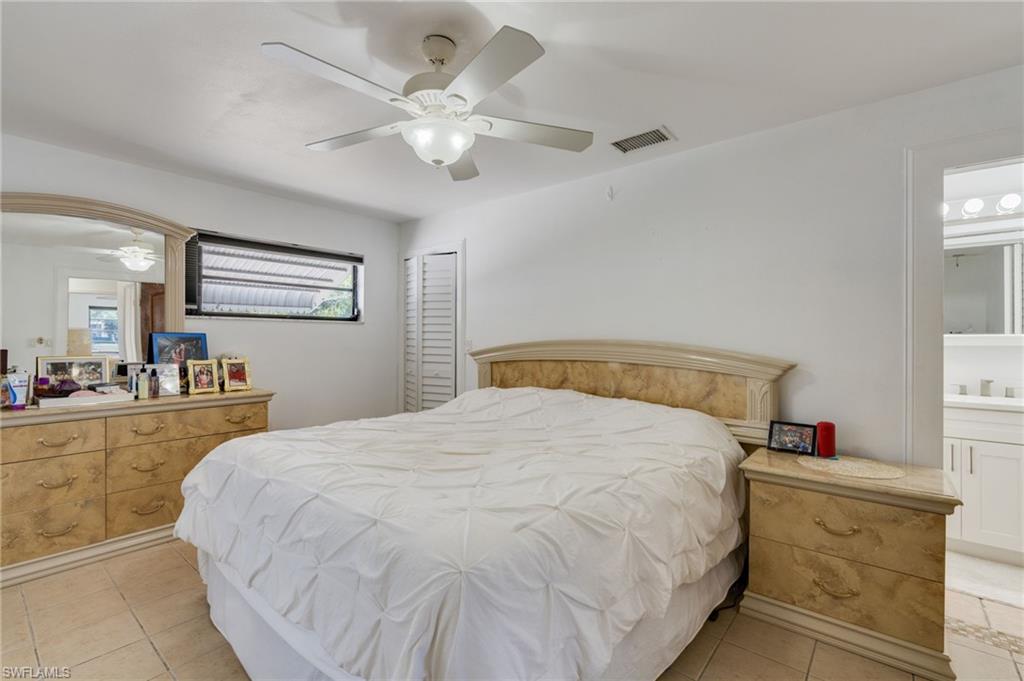 Spacious room featuring tile flooring, a window with horizontal blinds, and a ceiling fan with integrated lighting