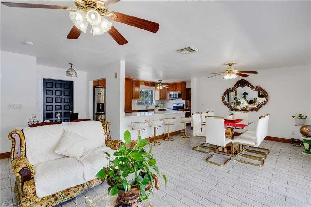 Open-concept living space with light-toned tile flooring throughout
