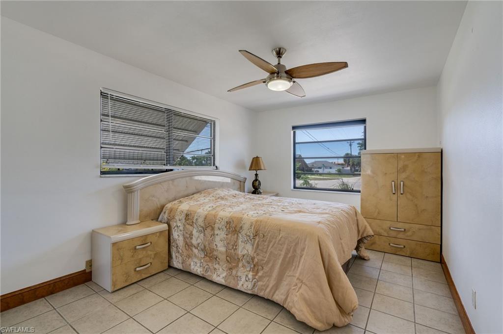 Room featuring neutral-toned tile flooring and white painted walls