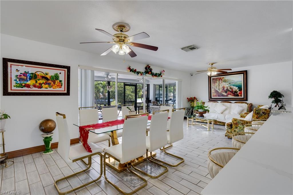 Open-concept living area with white tile flooring throughout