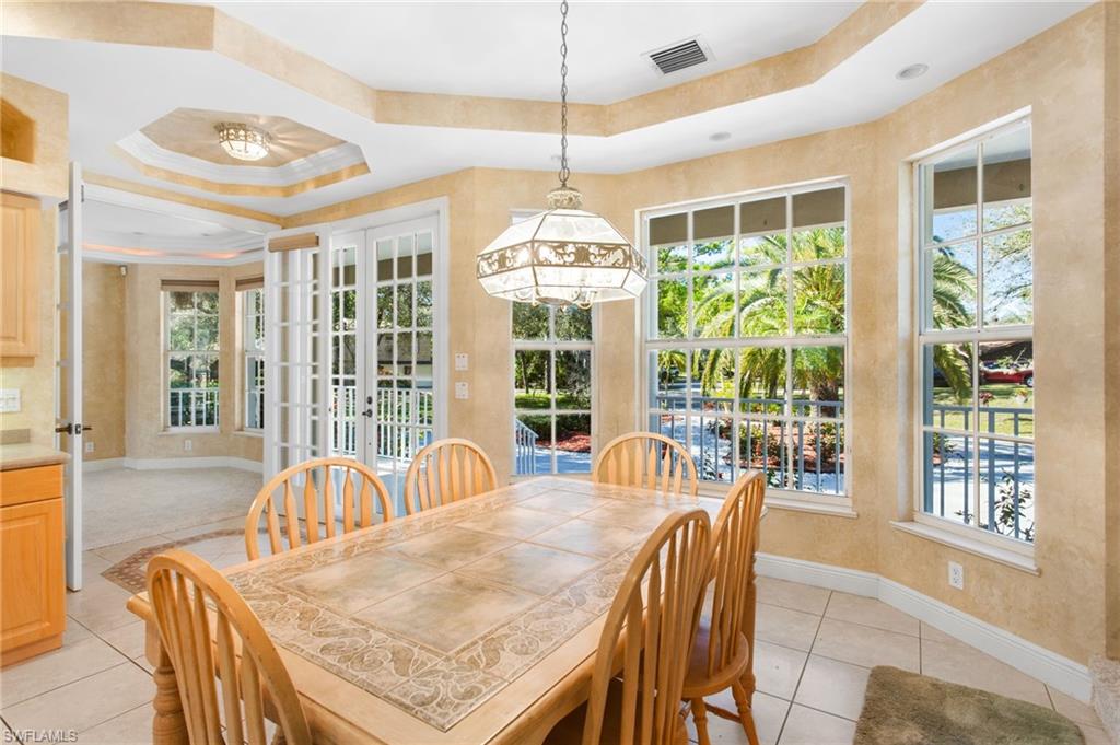 Dining area featuring multiple large windows and French doors