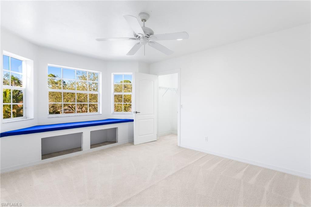 Bright room featuring a multi-pane window bay with a built-in window bench and storage cubbies