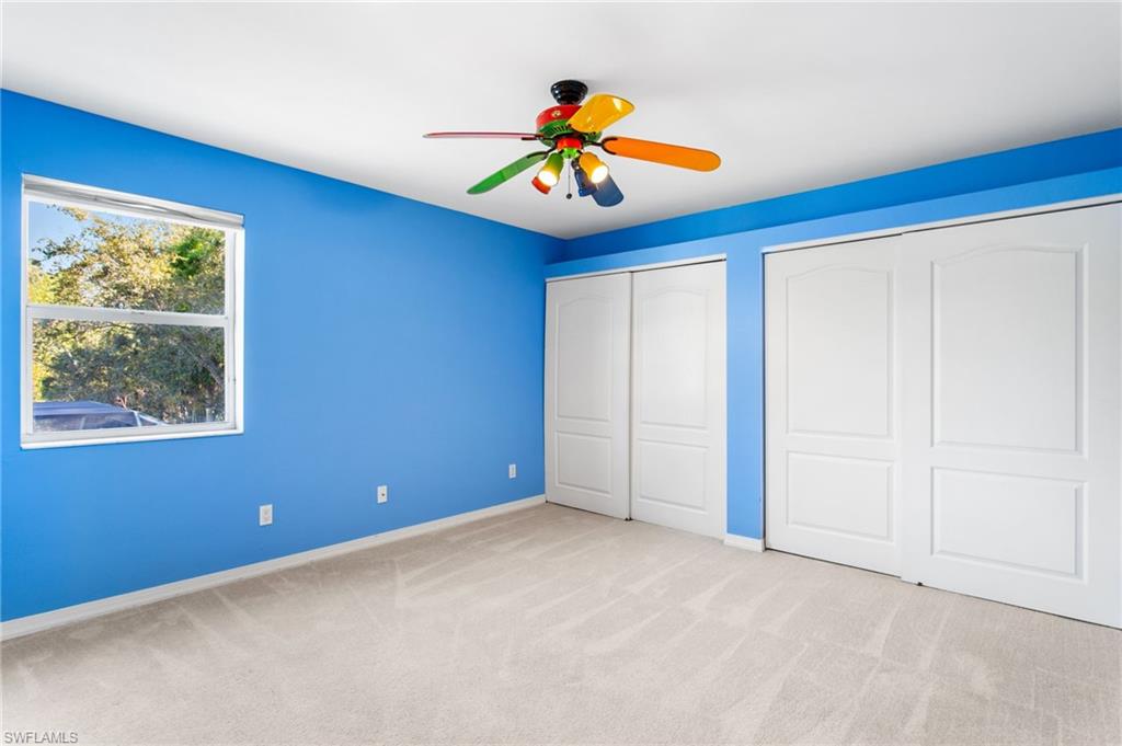 Interior space featuring blue walls and a light-colored carpet