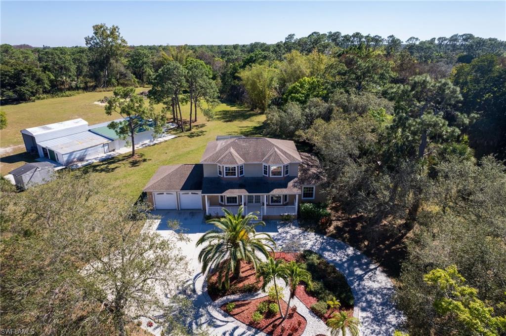 Two-story residence featuring a three-car garage, front porch, and bay windows