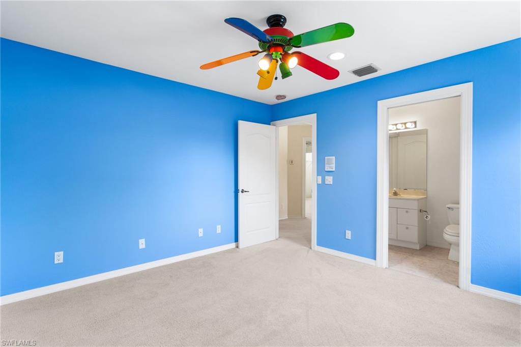 Carpeted room with a ceiling fan, recessed lighting, and a white baseboard trim