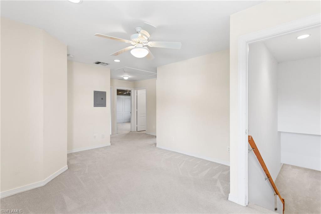 Open concept room featuring a ceiling fan with light fixture, recessed lighting, neutral carpet flooring, and light-toned walls