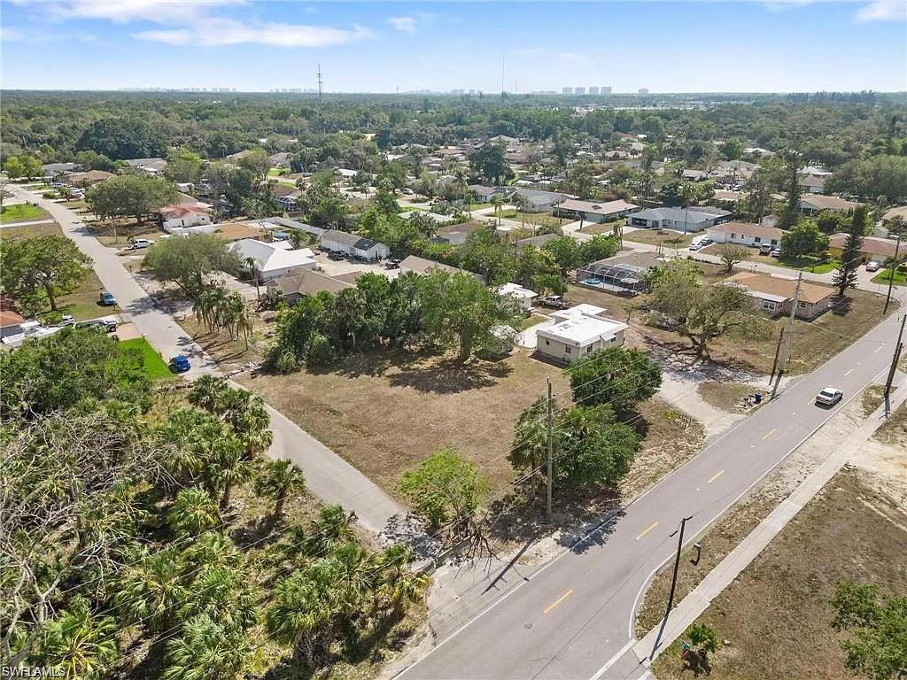 Expansive cleared lot at a corner intersection, offering significant space for development