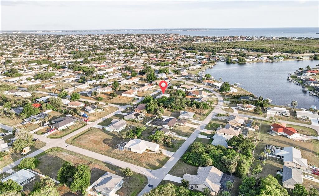 Aerial view showcasing a residential area with waterways and distant coastal features